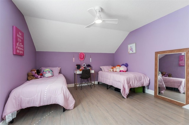 bedroom featuring vaulted ceiling, ceiling fan, and light wood-type flooring