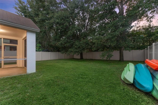 view of yard at dusk