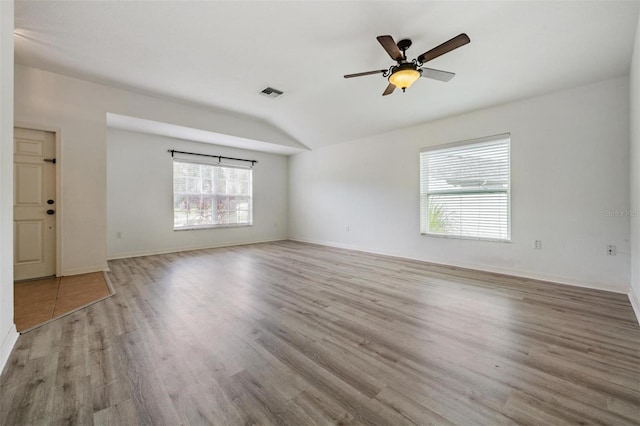 spare room featuring light wood-type flooring, ceiling fan, and vaulted ceiling