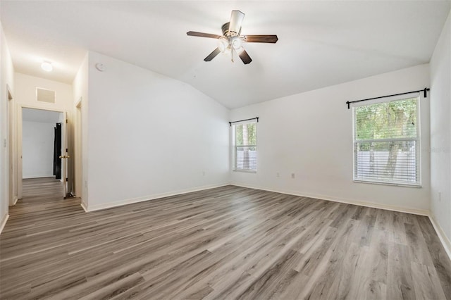 unfurnished room featuring ceiling fan, light wood-type flooring, and vaulted ceiling