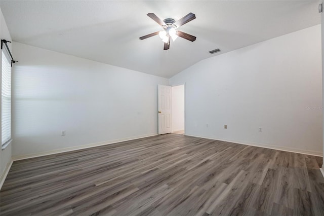 unfurnished room with dark hardwood / wood-style floors, vaulted ceiling, and ceiling fan