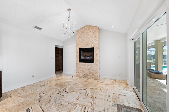 unfurnished living room featuring a large fireplace, a notable chandelier, and lofted ceiling