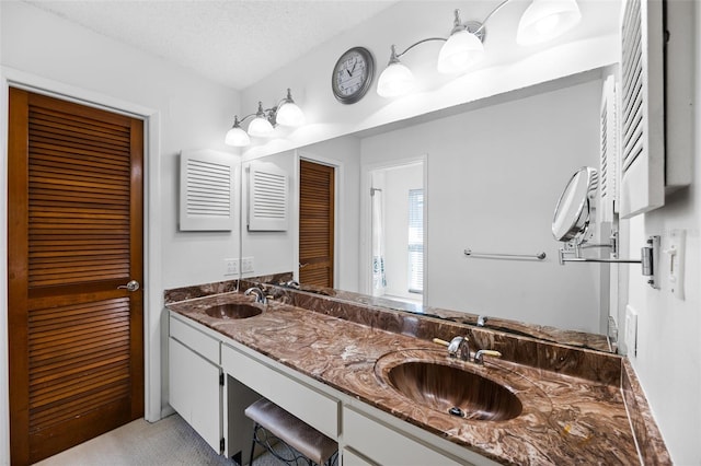 bathroom with vanity and a textured ceiling