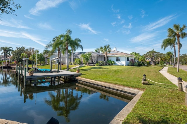 view of dock with a water view, a lanai, and a lawn