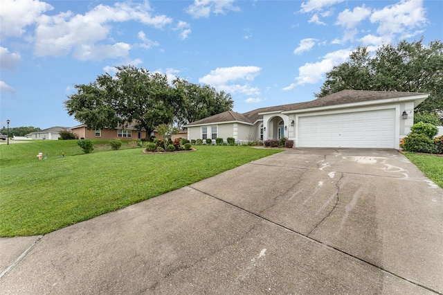 ranch-style home with a garage and a front lawn