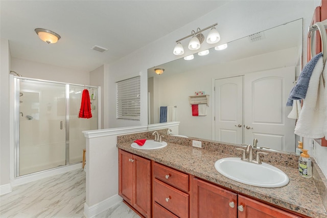 bathroom with walk in shower and vanity