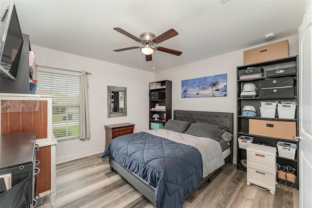 bedroom with ceiling fan and hardwood / wood-style floors