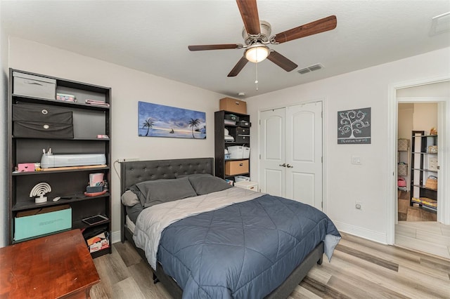 bedroom featuring a closet, hardwood / wood-style flooring, and ceiling fan