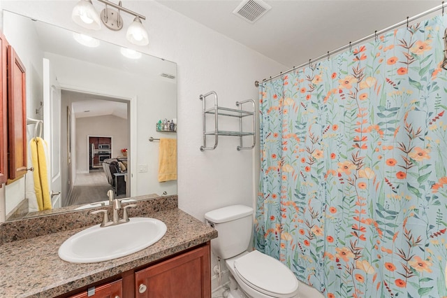 bathroom featuring lofted ceiling, vanity, toilet, and a shower with curtain