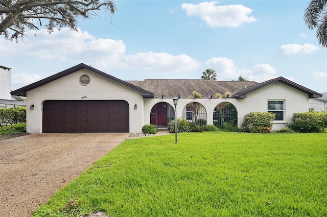 ranch-style house featuring a garage and a front lawn