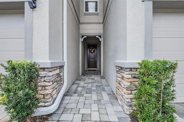 view of exterior entry featuring a garage