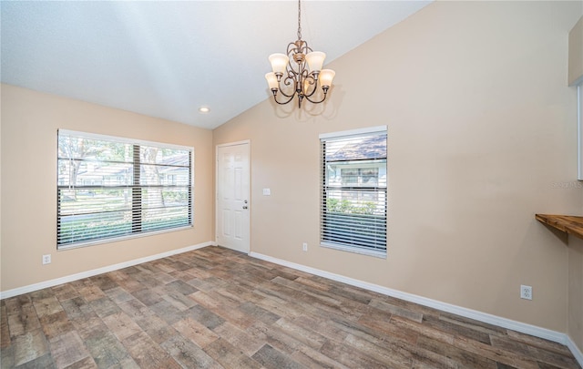 interior space with hardwood / wood-style flooring, lofted ceiling, and a notable chandelier