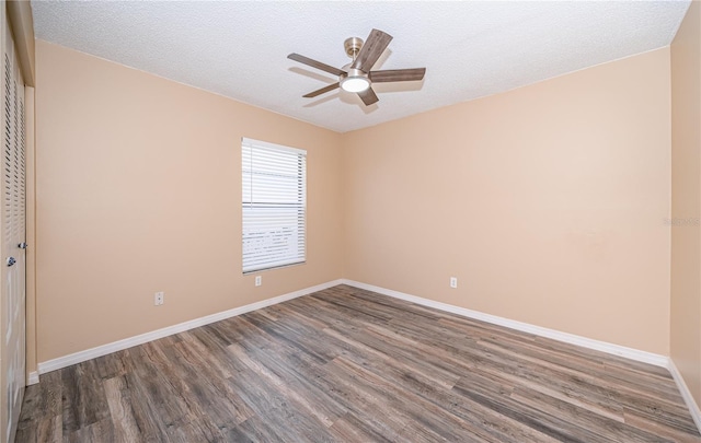 spare room with hardwood / wood-style floors, ceiling fan, and a textured ceiling