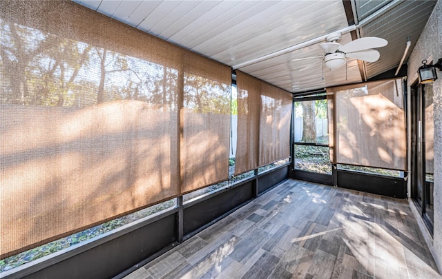 unfurnished sunroom featuring ceiling fan