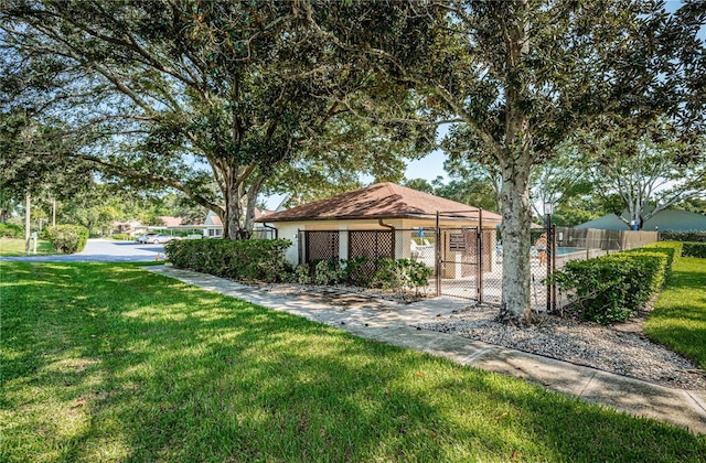 view of front of house with a front lawn and a community pool