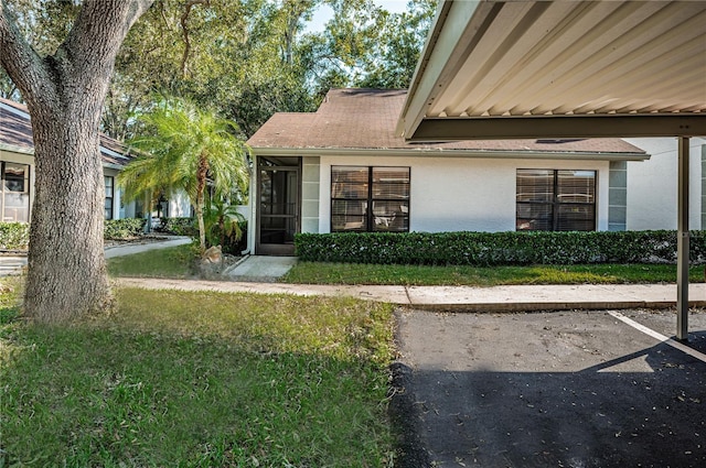 doorway to property with a yard