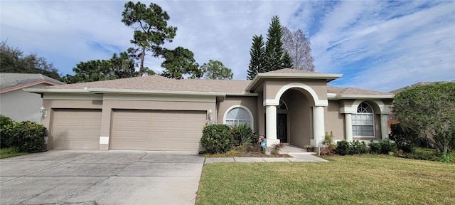 view of front facade featuring a garage and a front lawn