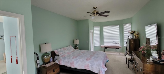 bedroom featuring light carpet and ceiling fan