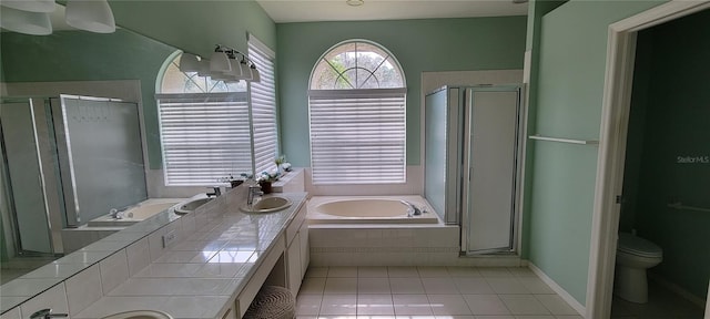 full bathroom with independent shower and bath, vanity, toilet, and tile patterned floors