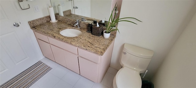 bathroom with vanity, tile patterned flooring, and toilet