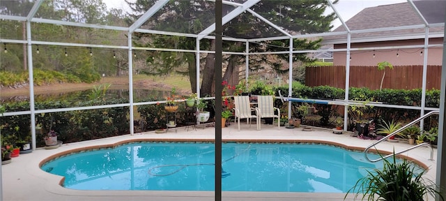 view of swimming pool featuring a lanai and a patio area