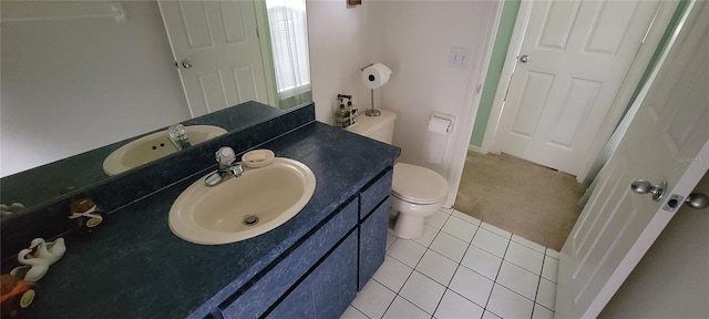 bathroom with tile patterned floors, vanity, and toilet