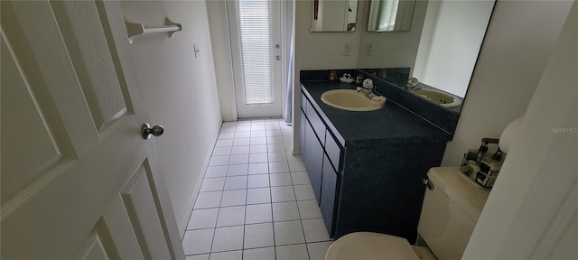 bathroom featuring vanity, tile patterned flooring, and toilet