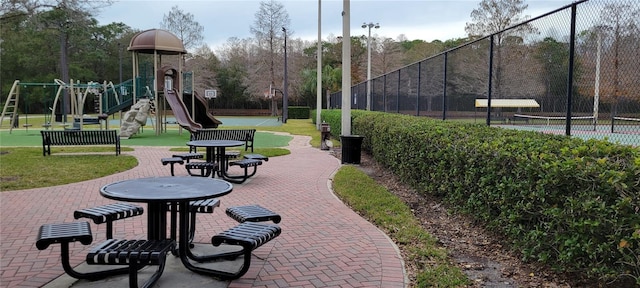 view of home's community featuring a playground and a lawn