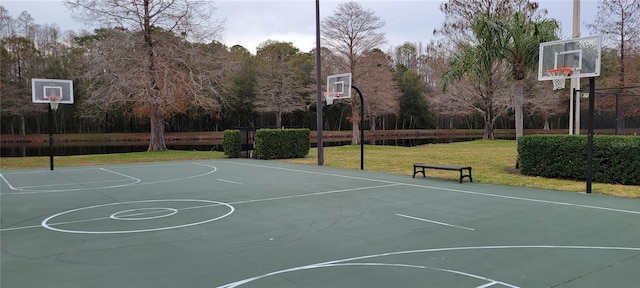 view of sport court with a yard