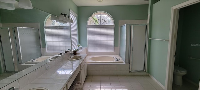 full bathroom featuring tile patterned flooring, plus walk in shower, vanity, and toilet