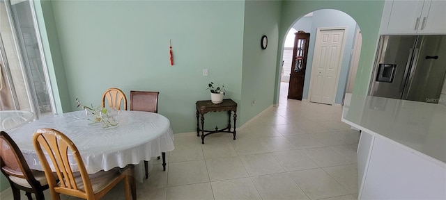 dining space with plenty of natural light and light tile patterned floors