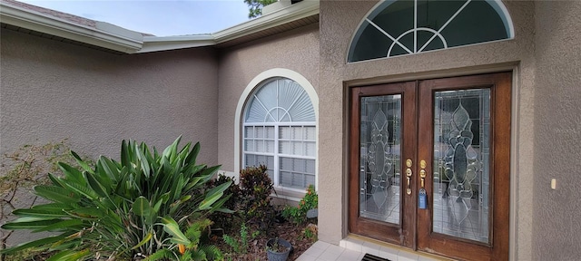 view of exterior entry featuring french doors