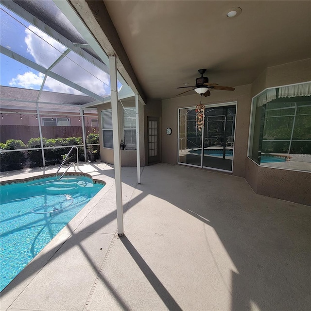 view of pool with a patio, a lanai, and ceiling fan