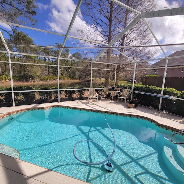 view of swimming pool with a patio area and glass enclosure