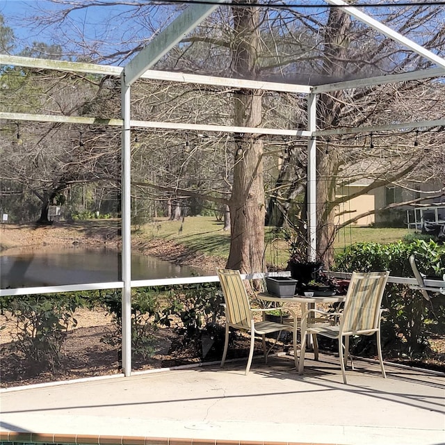 unfurnished sunroom with a water view