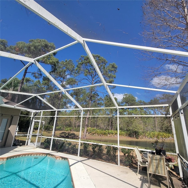 view of swimming pool featuring a lanai and a patio