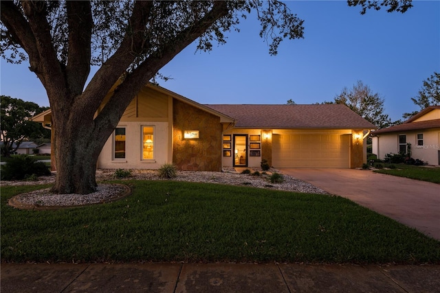 view of front facade featuring a garage and a lawn