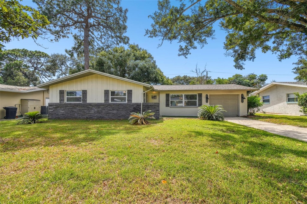 ranch-style home with a garage and a front yard