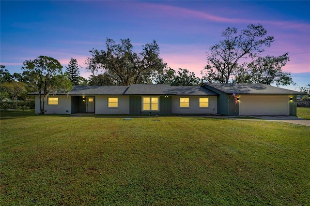 single story home with a yard and a garage