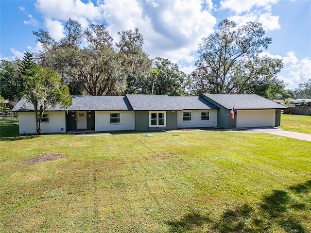 ranch-style home with a front yard and a garage