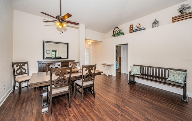 dining room featuring high vaulted ceiling, ceiling fan, and dark wood-type flooring