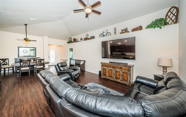 living room featuring ceiling fan, a textured ceiling, dark hardwood / wood-style floors, and vaulted ceiling