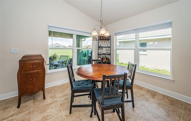 dining area featuring lofted ceiling and a notable chandelier