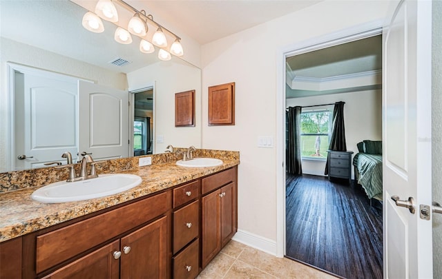 bathroom with vanity, crown molding, and hardwood / wood-style floors