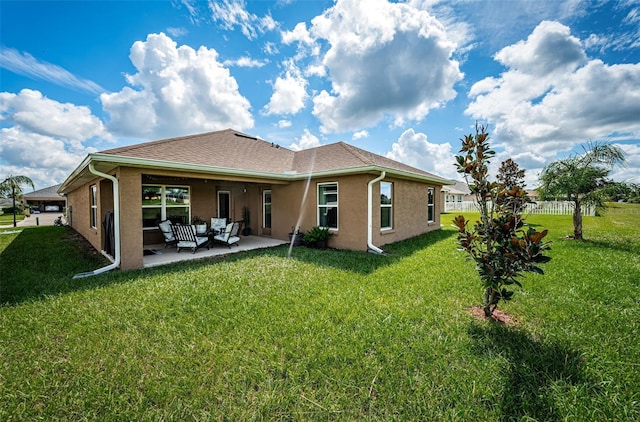 rear view of property with a patio area and a lawn