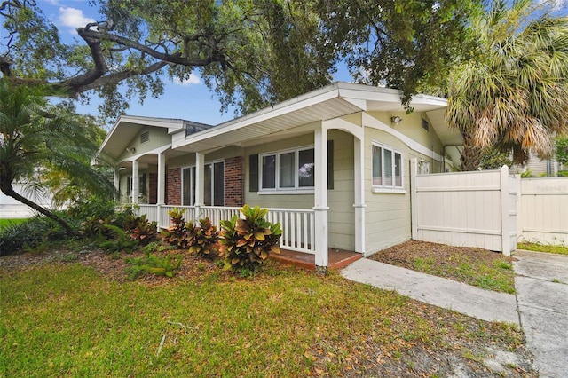 view of home's exterior featuring a yard and a porch