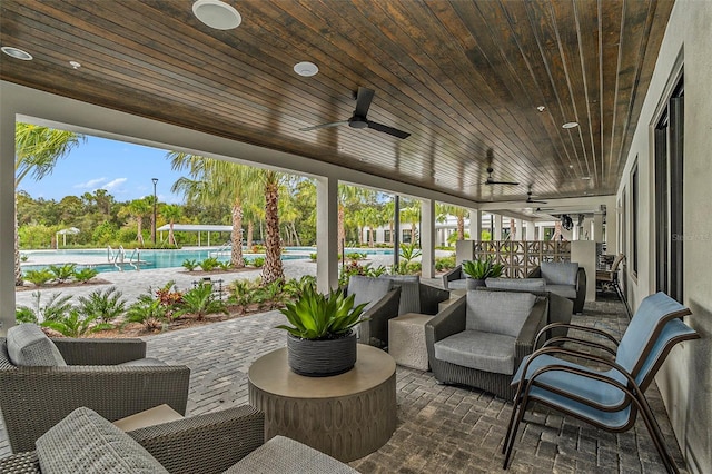 exterior space with ceiling fan, wood ceiling, and plenty of natural light