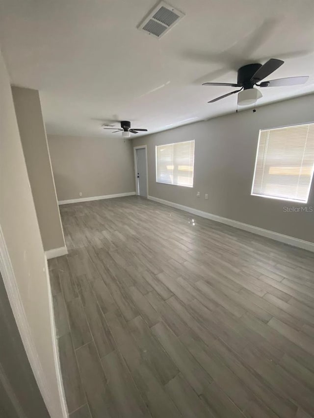 empty room with wood-type flooring and ceiling fan