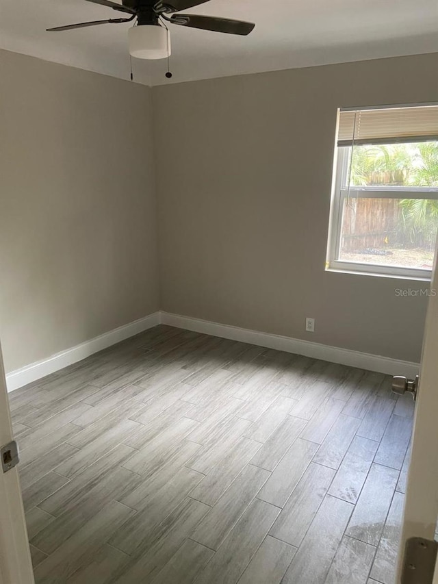 empty room featuring ceiling fan and light hardwood / wood-style floors