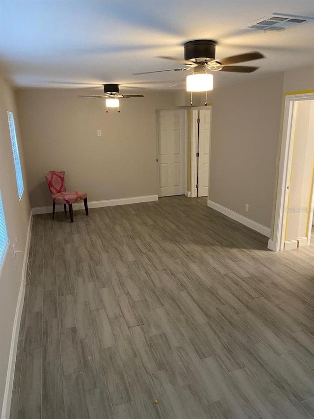 spare room featuring hardwood / wood-style floors and ceiling fan